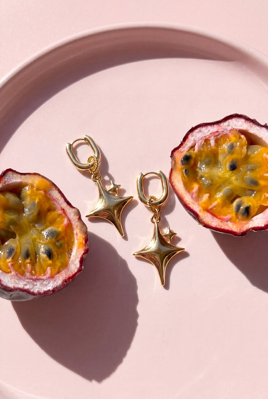 Squoval earrings with glittering star pendant
