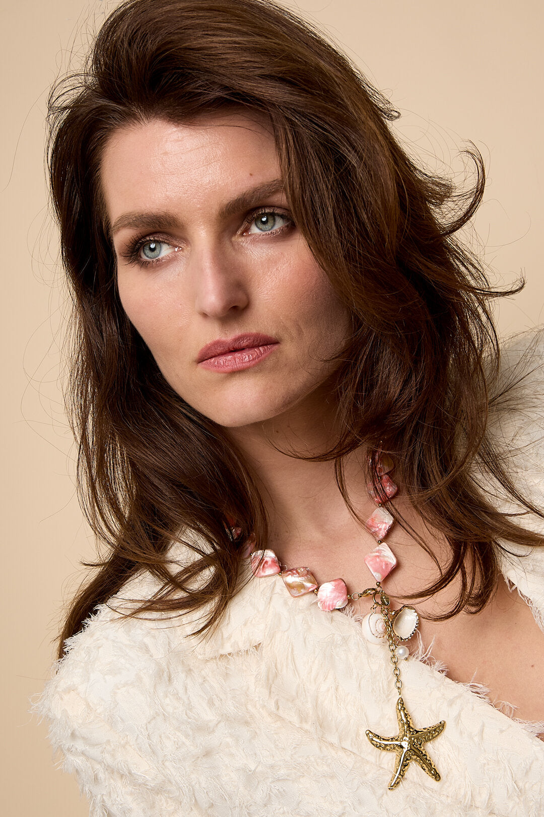 Necklace with seashell beads, charms, and a hanging starfish