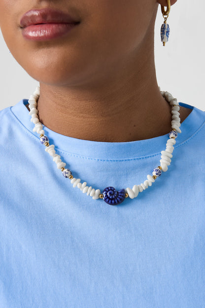 Necklace with stone beads, white beads with blue flowers and statement shell