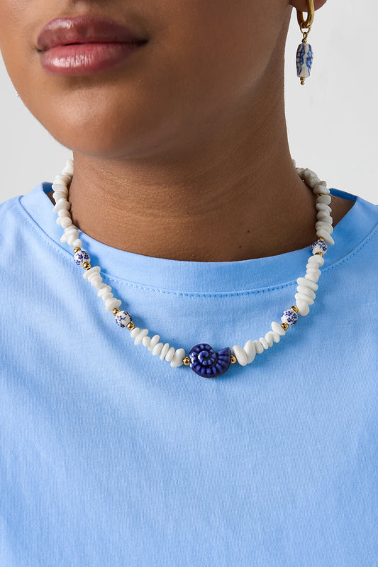 Necklace with stone beads, white beads with blue flowers and statement shell