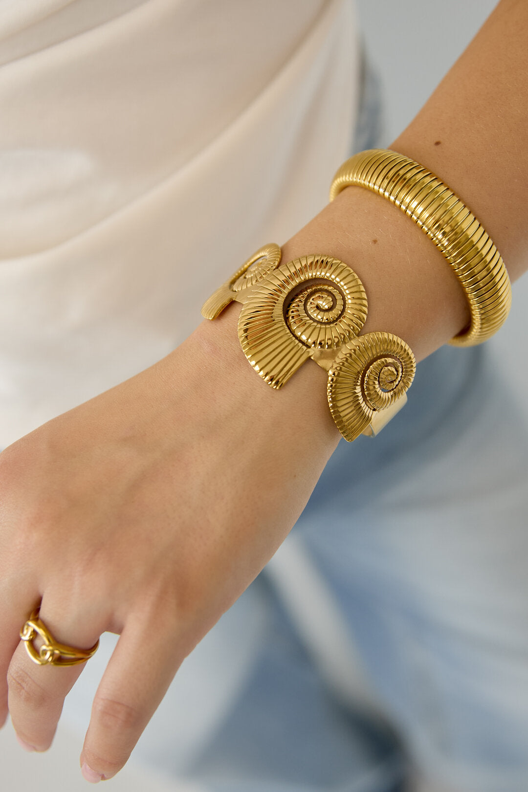 Cuff statement bracelet with spiral shells