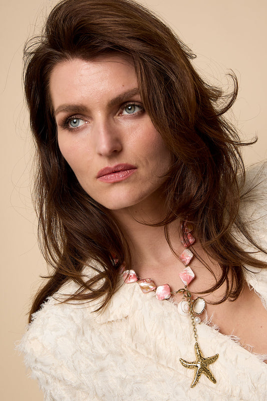 Necklace with seashell beads, charms, and a hanging starfish