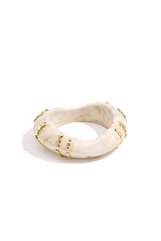Resin bangle bracelet with studs in a striped pattern