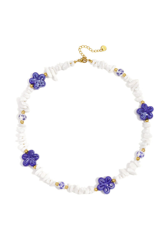 Necklace with stone beads, white beads with blue flowers and statement flowers