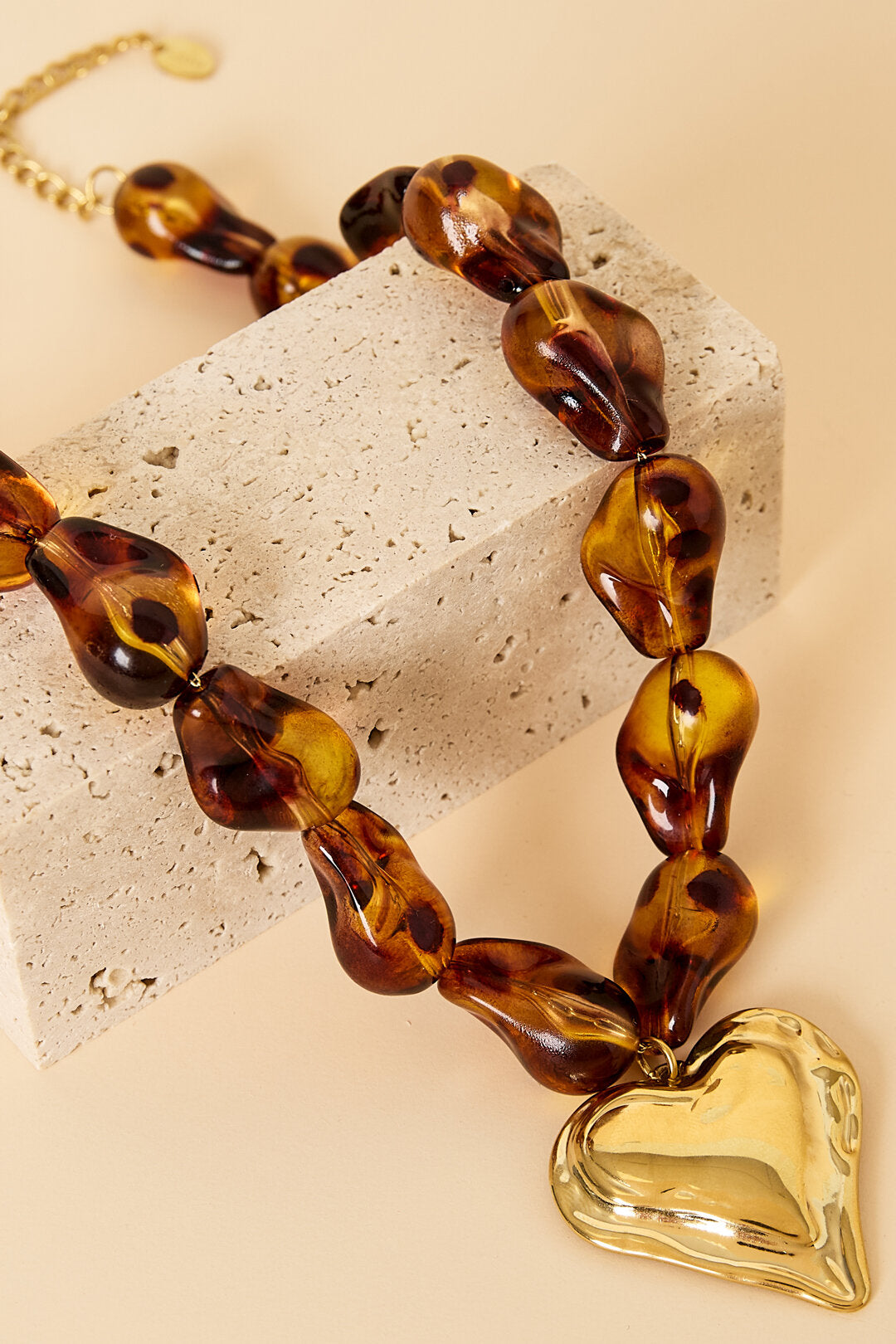 Beaded necklace with naturally shaped beads and a hanging heart