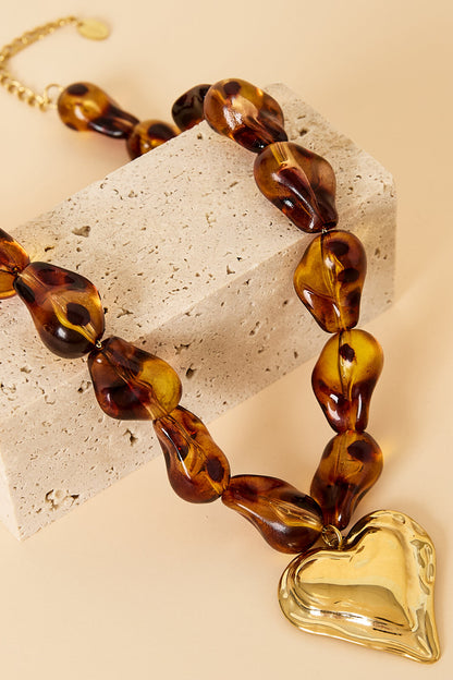 Beaded necklace with naturally shaped beads and a hanging heart