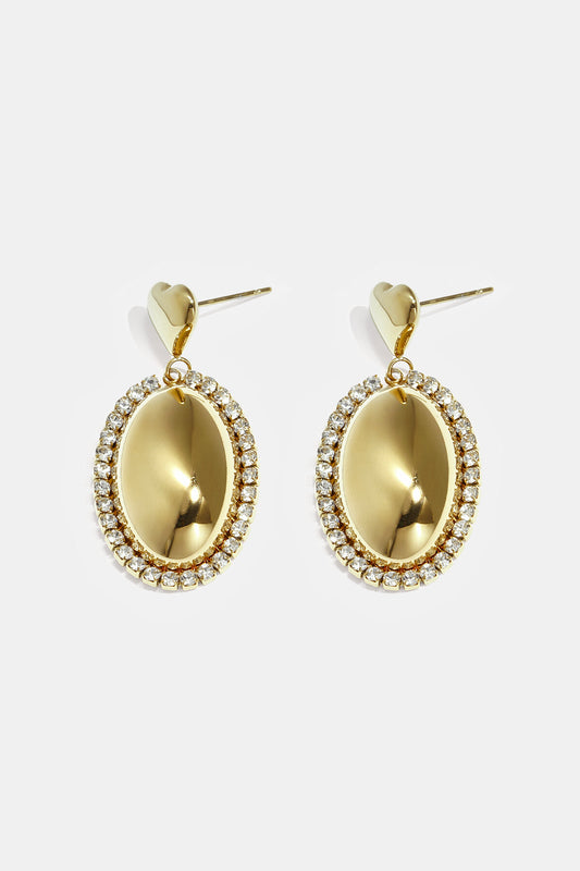 Statement earrings with an oval charm surrounded by stones